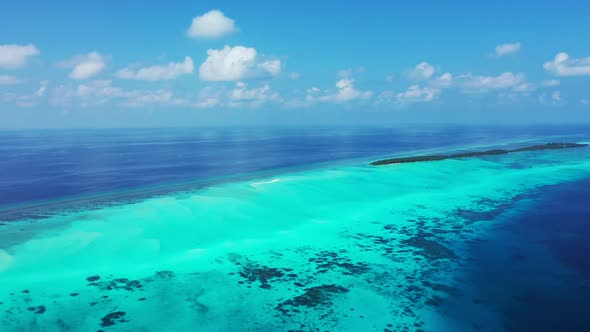 Aerial drone shot seascape of marine island beach time by shallow water with white sandy background  alt