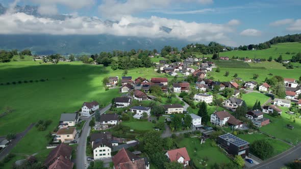 Aerial View of Liechtenstein with Houses on Green Fields in Alps Mountain Valley alt