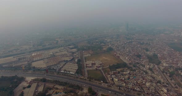 Bombay, India, Aerial flight of the city, two highways with traffic, foggy weather alt