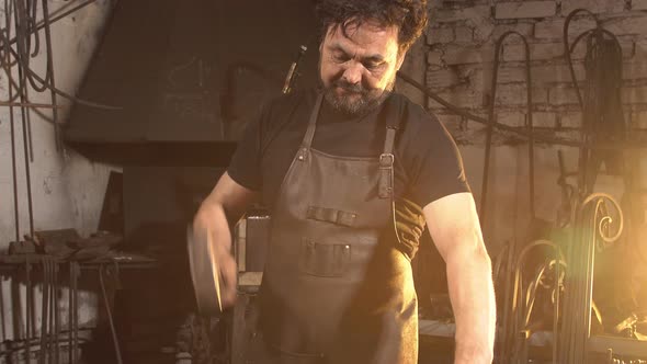 Blacksmith Forges on the Anvil. Brutal Man Working at the Forge with Metal.