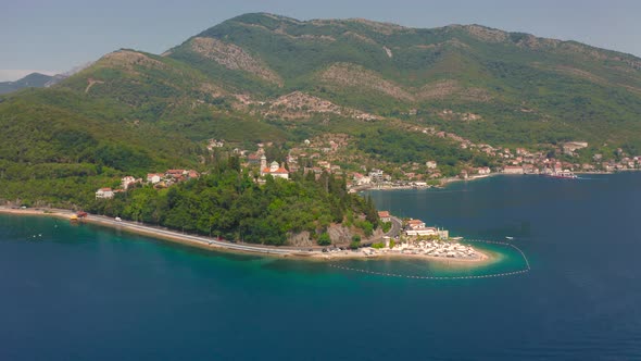 Aerial View of Huge Mountains and Small Sandy Beach of Kotor Bay Montenegro alt