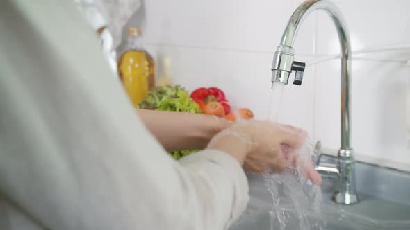Slow motion Close up of Female Chef Washing Her Hand
