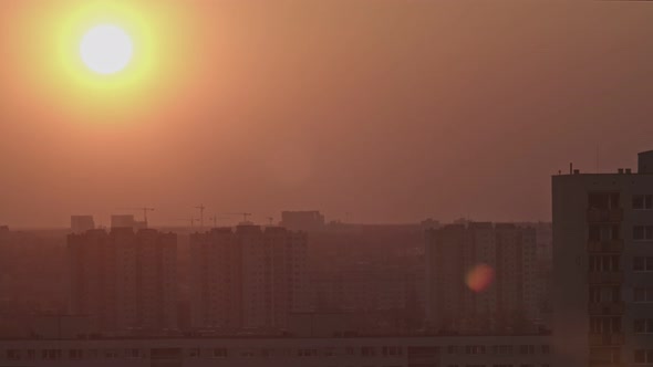 Time Lapse Shot of the Sunset The Sun Hides Behind the Buildings