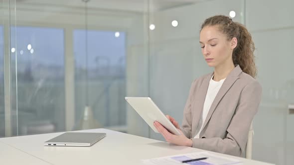 Hardworking Young Businesswoman Using Tablet in Modern Office alt