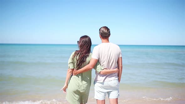 Young Couple on White Beach During Summer Vacation.