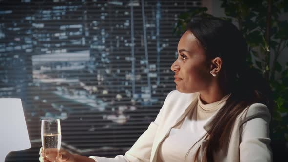 Close Up of African American Business Woman Making Toast with Bocal of Champagne at Business Lunch alt