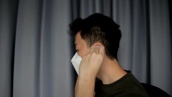 Side View Of A Young Asian Man Wearing Mask