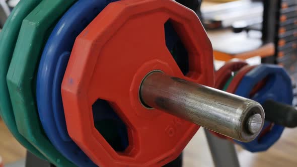 The Bodybuilder's Hand Removes Excess Discs From the Bar to Reduce Weight When Performing a Deadlift