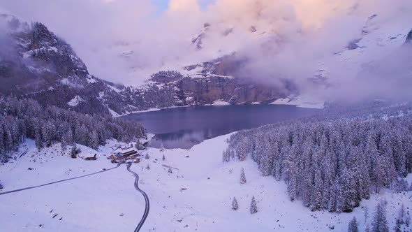 Oeschinen Lake in the Snowy Mountains of Switzerland on a Foggy Morning alt