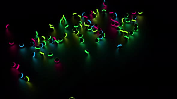 Many black children toy balls with neon lights falling on the floor alt