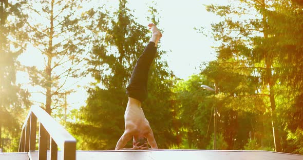 Sporty Man Doing Headstand in the Morning alt