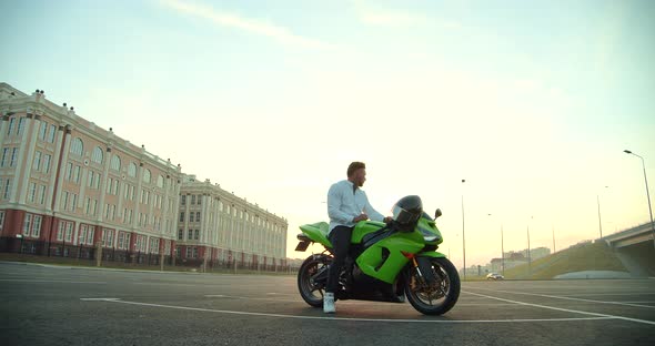 Stylish Businessman with Moto Scooter on Urban Street