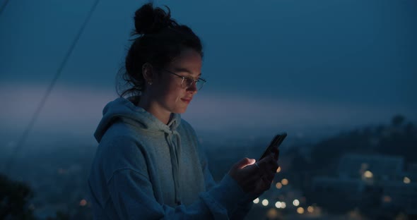 Young Woman Look at Phone in Sunset Light