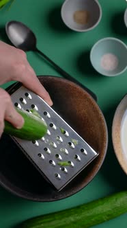 Vertical Flat Lay Video Recipes Chef Grates Cucumber on the Grater