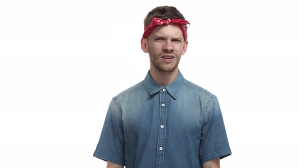Handsome Bearded Hipster Guy with Red Hip Hop Bandana Looking Confused and Frowning Then Begin to
