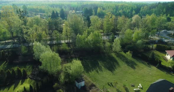 Drone point of view of a housing estate in the suburbs surrounded by forest. alt