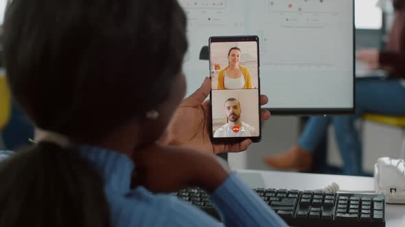 Handicapped Invalid African Manager Talking on Videocall with Friends alt