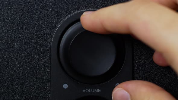 Woman adjusts the volume. Adjusts the volume of the stereo speakers. alt