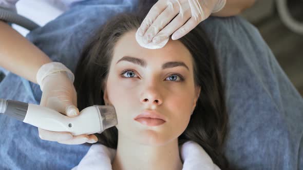Young Woman Getting Radio Frequency Lifting Procedure in a Beauty Salon alt