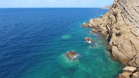 Clear Sea Water of the Promontory Headland Surrounded by Stone and Rocky Coastline