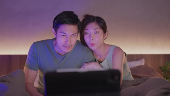 marry couple exited watching horror ghost online movie broadcast from laptop