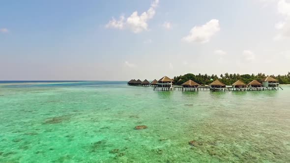 Aerial View of Luxurious Overwater Bungalows at Villas Resort in Maldives Islands 01