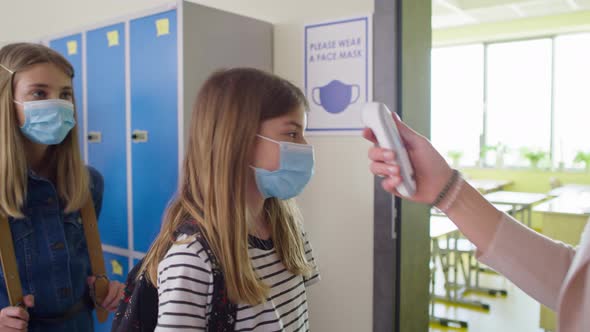 Video of teacher checks temperature of students at school. Shot with RED helium camera in 8K alt