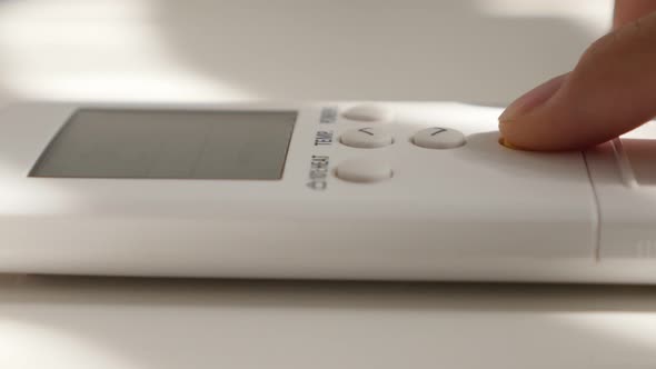 Lowering room temperature on air conditioner  remote control 4K 2160p UltraHD footage - Finger on ai alt