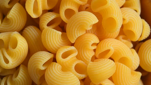 Uncooked macaroni pasta rotating