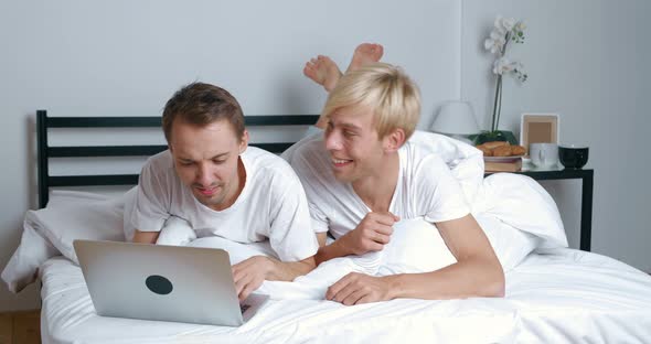 Loving Male Gay Couple Spend Time at Home Lying on Bed alt