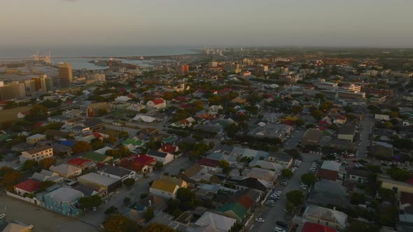 Slide and Pan Aerial Shot of Buildings in Residential Urban Neighbourhood at Sunset alt