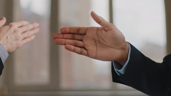 Closeup Funny Male Greeting Gesture of Partnership Two Man African and Caucasian Business Colleagues alt