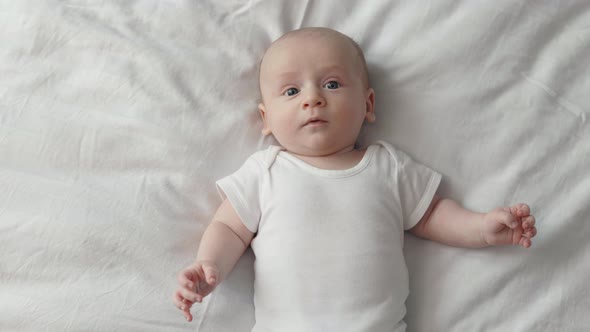 Top View of Newborn Boy Lying Alone in Bed, Stock Footage | VideoHive