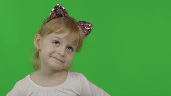 Girl in Headband with a Cat Ears Shows Amazement. Happy Four Years Old Child alt