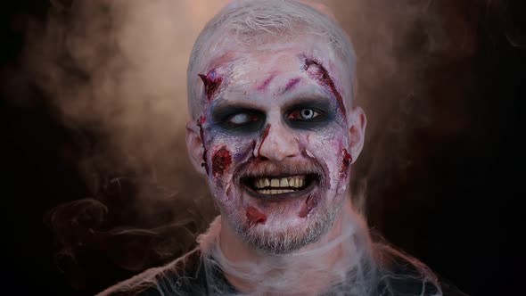 Unexpected Appearance of Sinister Man with Horrible Scary Halloween Zombie Makeup Trying to Scare alt