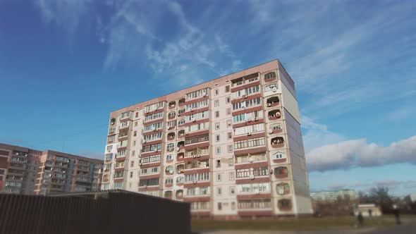 Hyperlapse of a Multistory Old Building Against a Blue Sky and Moving Clouds alt