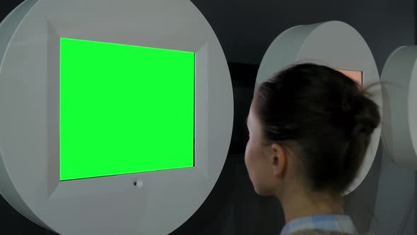 Green Screen Concept - Woman Looking at Blank Green Display Wall at Exhibition