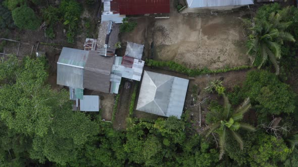 Aerial top down view of a large lodge next to a tropical river alt
