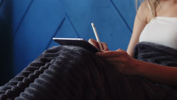 Closeup of Womans Hands Drawing on Graphic Tablet Lying Bed in Her Room with Stylus alt