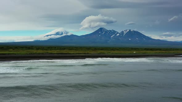 Beach with Black Sand and Volcano alt