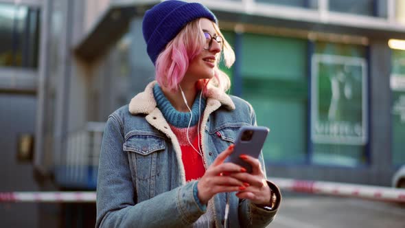 Pensive woman in hat listening music and looking around alt
