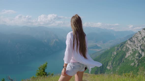 Girl Looks at the Panorama of Lake Garda From the Mountains alt