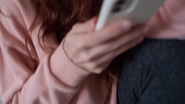 Tracking video of anxious young caucasian woman using mobile phone. alt