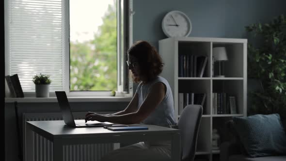 Woman Using Laptop at Home