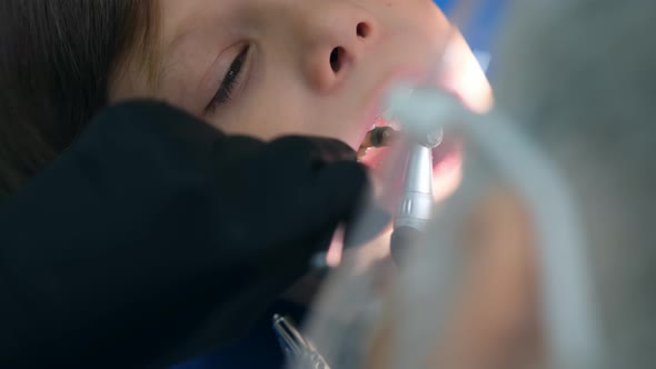 Dentist Hygienist Making Oral Hygienic Cleaning in Dentistry for Teen Child Boy