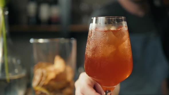 Aperol Spritz Cocktail with Orange Slices and Ice on Black Tray on Dark for Celebration Water Drops alt