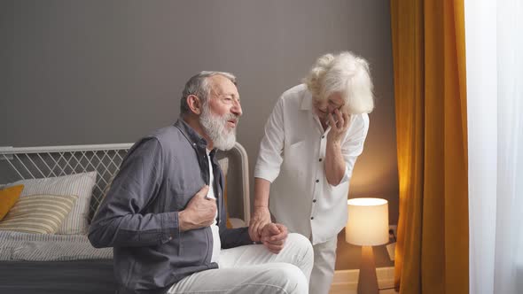 Caucasian Senior Couple at Home Elderly Wife Call an Ambulance to Help Husband with Heart Attack
