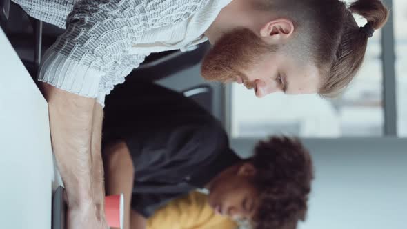 Vertical Screen Bearded Hipster Working on Laptop in Office alt