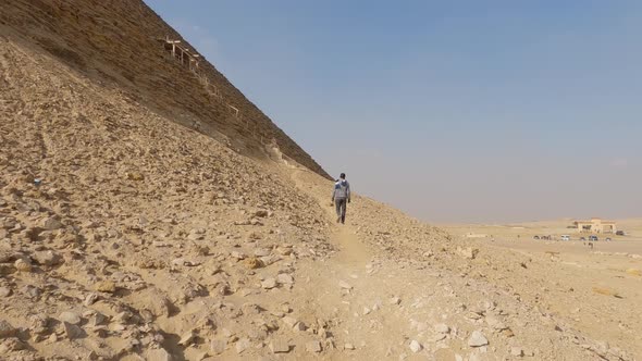 Tourist Hiking Around The Ancient Egyptian Dahshur Red Pyramid In Egypt alt