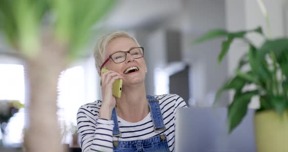 Mature woman with eyeglasses talking on the phone